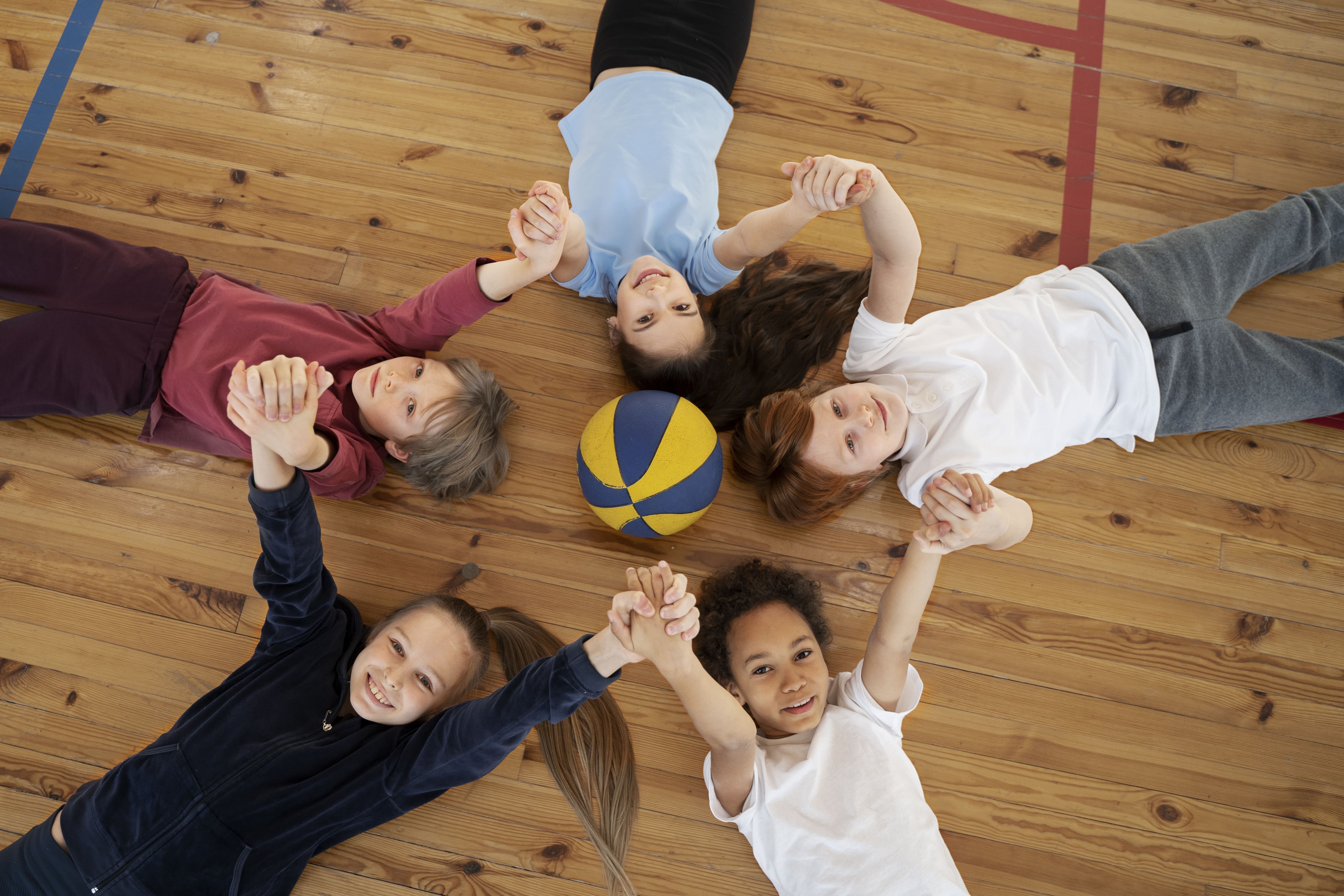 medium-shot-kids-laying-gym-floor(1).jpg