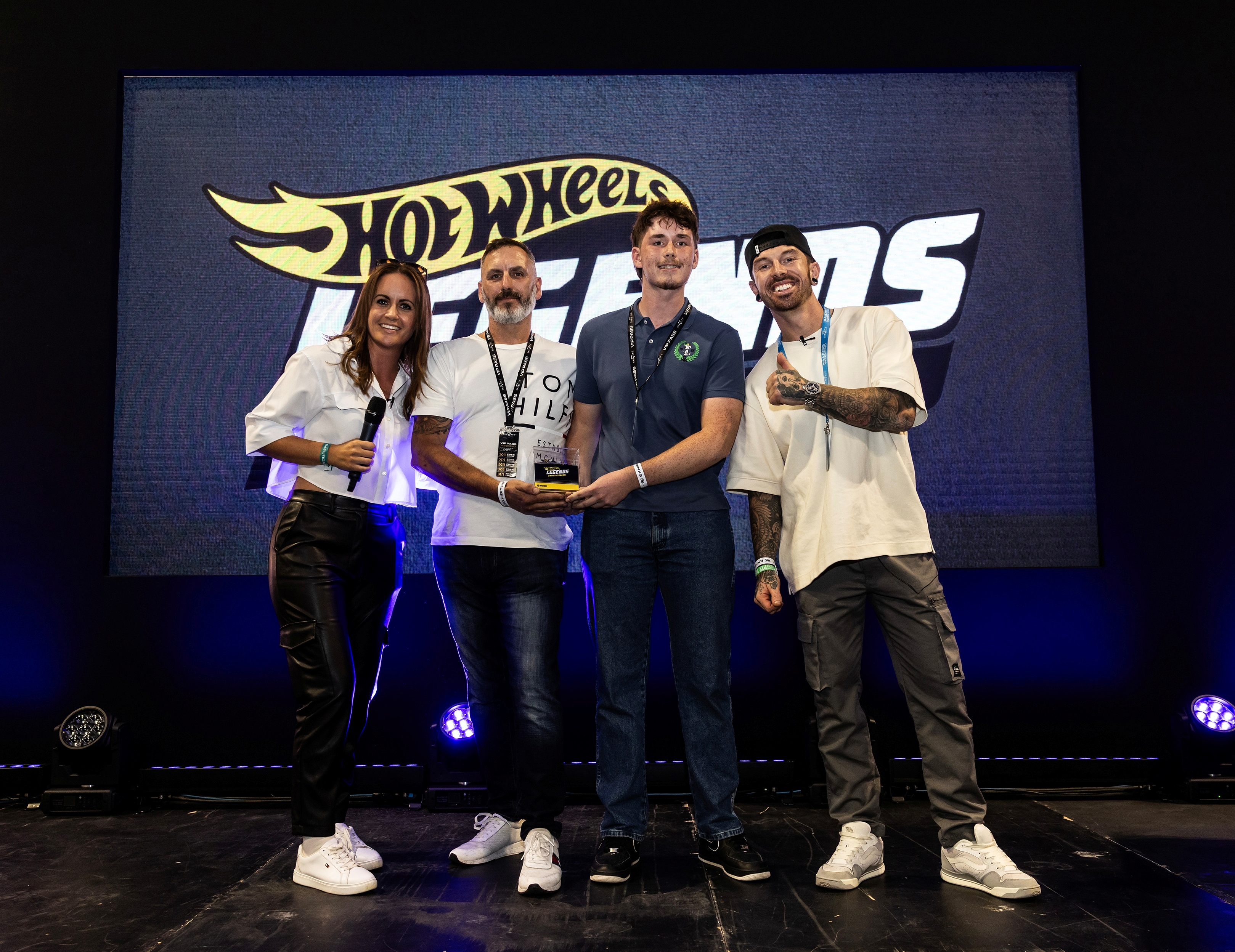 Winners Paul and Ethan Foster on stage with Nicola Hume and Mat Armstrong.jpg